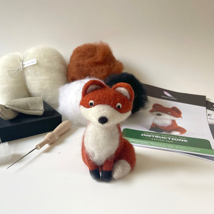Felted fox toy with needle felting tools and instructions on a white background